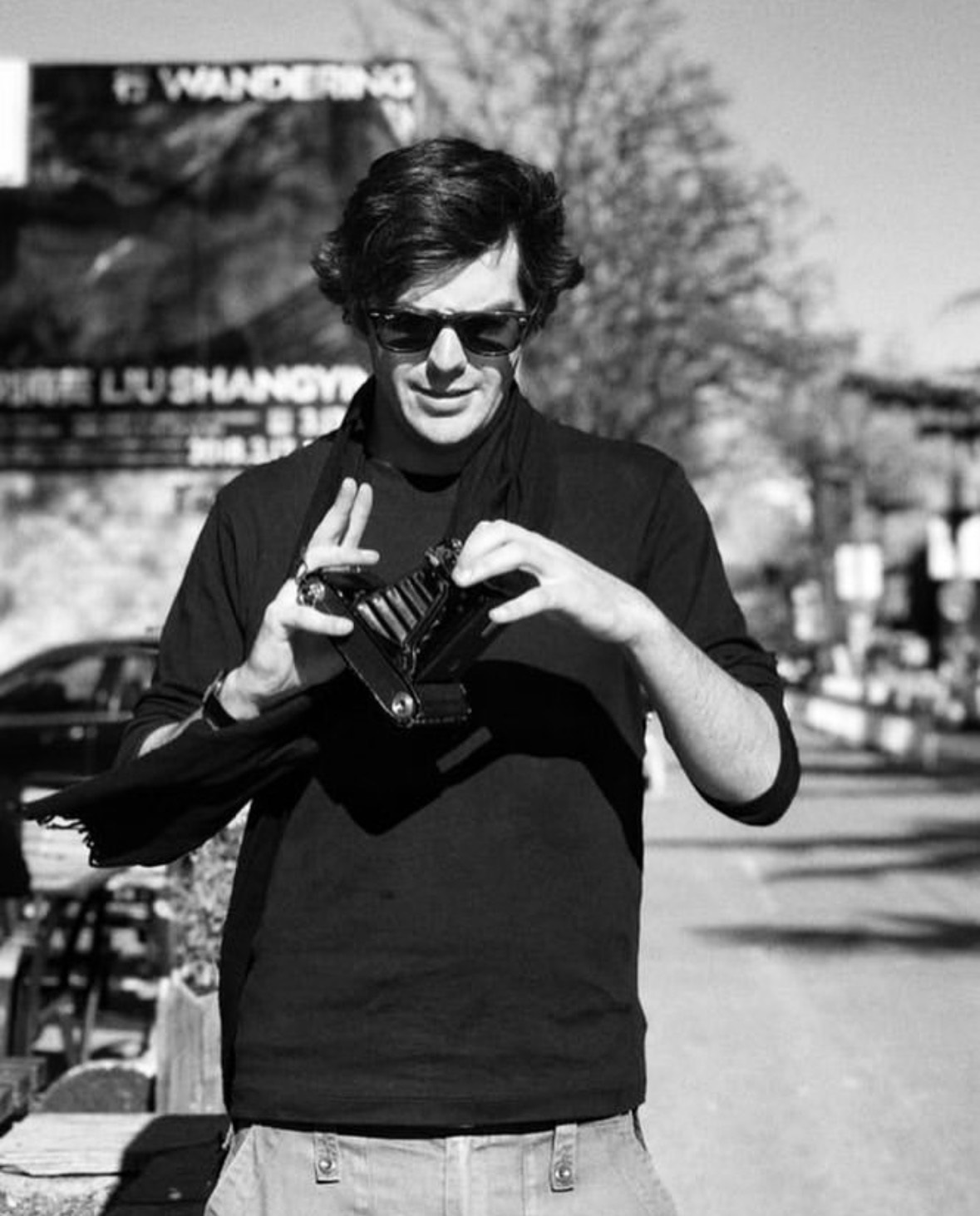 Photograph of Hubert Cecil holding camera
